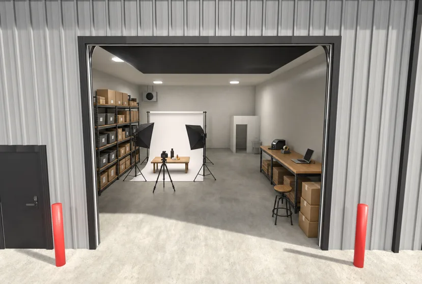 Rendering of a garage condo set up for an online business with stocked shelving, a product photo studio, and a packing bench.
